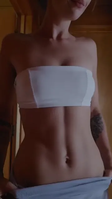 Tattooed Woman Lowers Waistband in White Bandeau