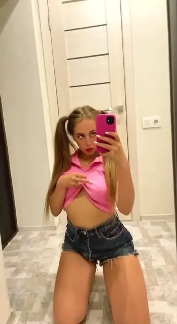 Blonde Takes a Mirror Selfie in a Pink Top