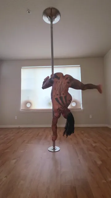 Tattooed Nude Woman Performs Inverted Pole Spins