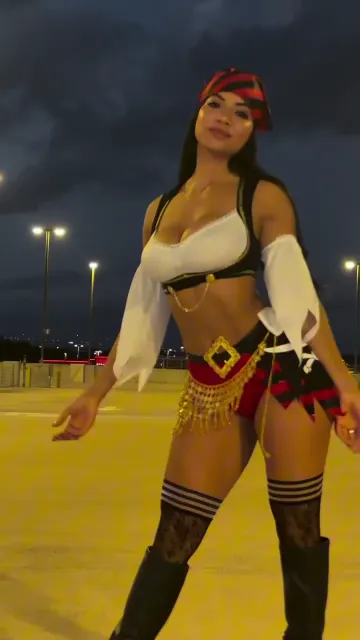 Woman Turns in a Pirate Outfit and Stockings Outdoors