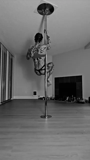 Tattooed Dancer Inverts on a Pole in Black and White