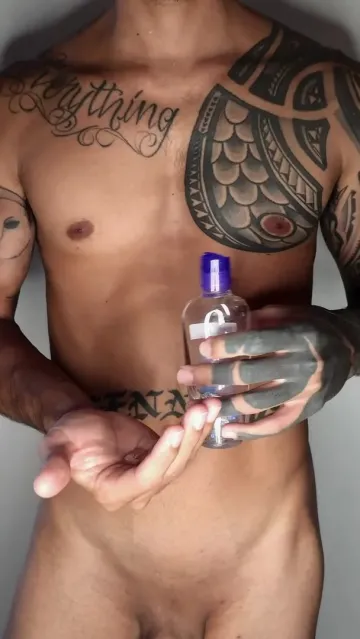 Tattooed Man Pours Liquid into His Palm