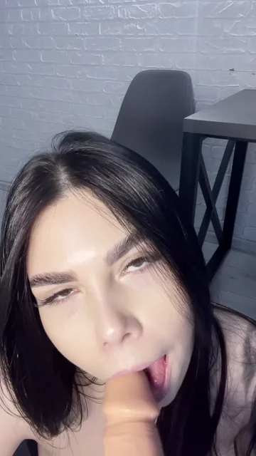 Brunette Sucks a Flesh Colored Dildo