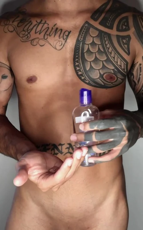 Tattooed Man Pours Liquid into His Palm