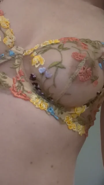 Woman Adjusts Floral Mesh Lingerie