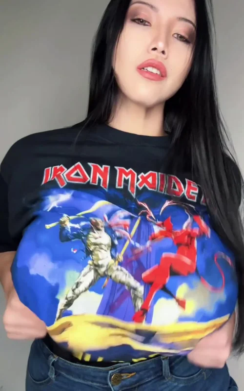 Black-Haired Woman Lifts Band T-Shirt